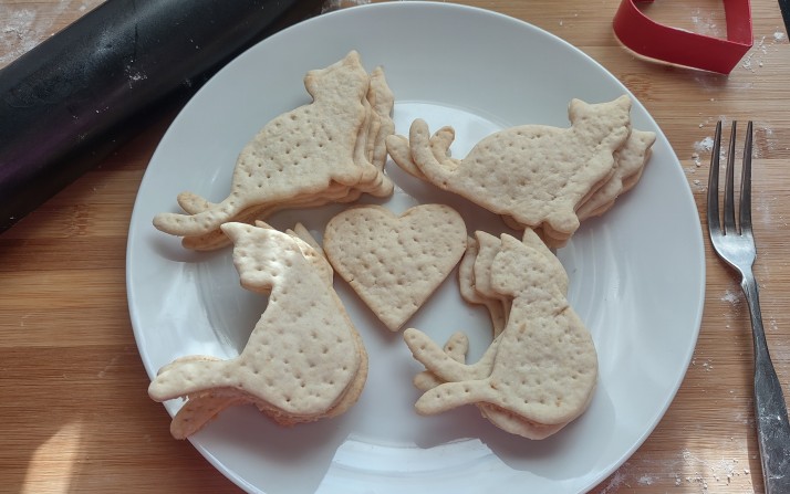 Cat-shaped and heart-shaped homemade crackers arranged on a plate.